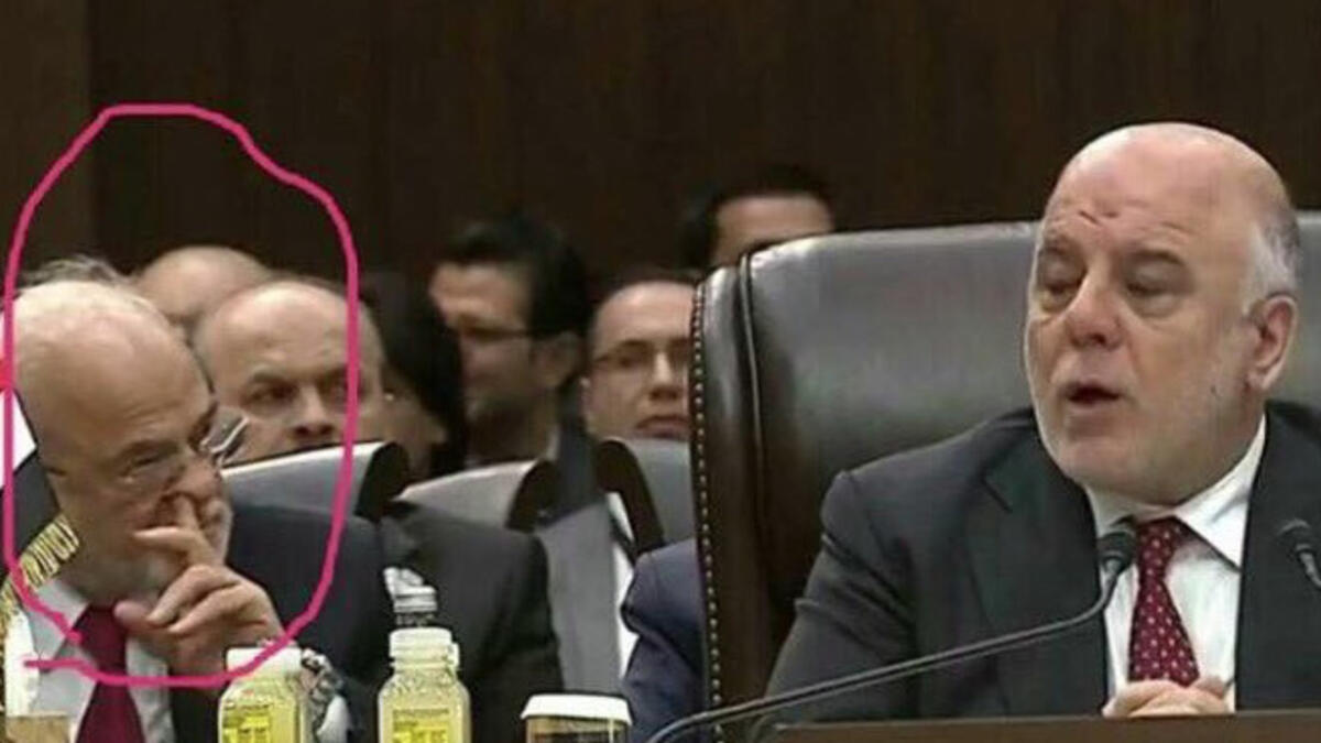 Diplomacy might not have been the first thing on the mind of this delegate seated next to Iraqi Prime Minister Haider al-Abadi - but he was definitely digging for something!