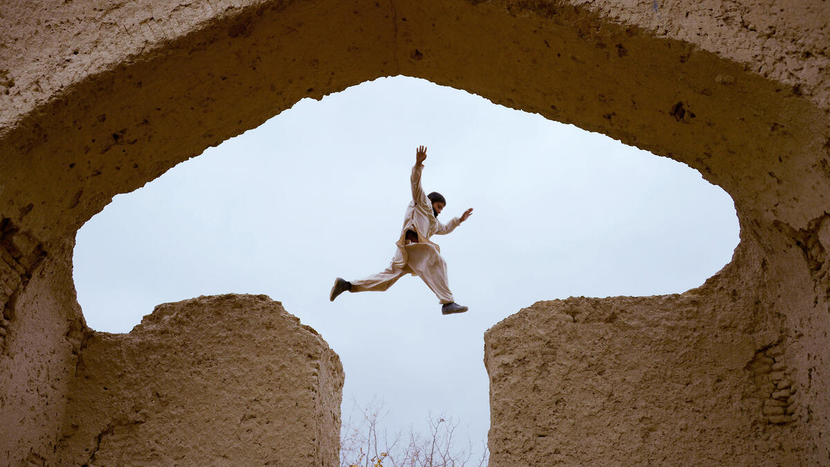 An Afghan boy plays in the ruins of a house that at one point belonged to the 13th-century Perisan poet, Jalal ad-Din Muhammad Rumi, on the outskirts of Mazar-i-Sharif.