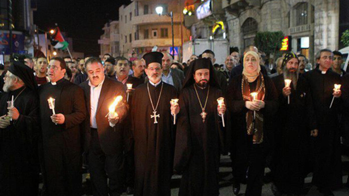 Palestinian Muslims and Christians marched in a candlelight vigil in Gaza in November 22, 2012. They gathered together in solidarity after the death of a Christian member of the Palestinian Legislative Council.