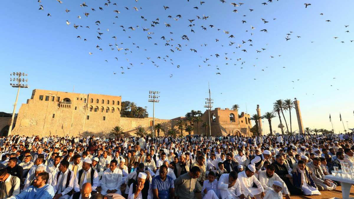 Muslim worshippers perform Eid el-Fitr prayers at the Martyrs' Square in the Libyan capital Tripoli on June 25, 2017. Since the toppling of Muamar Gaddafi in 2011, the country remains trapped in a civil war. Since 2014, fighting mostly occurs between the two rival governments, the House of Representatives and General National Congress.