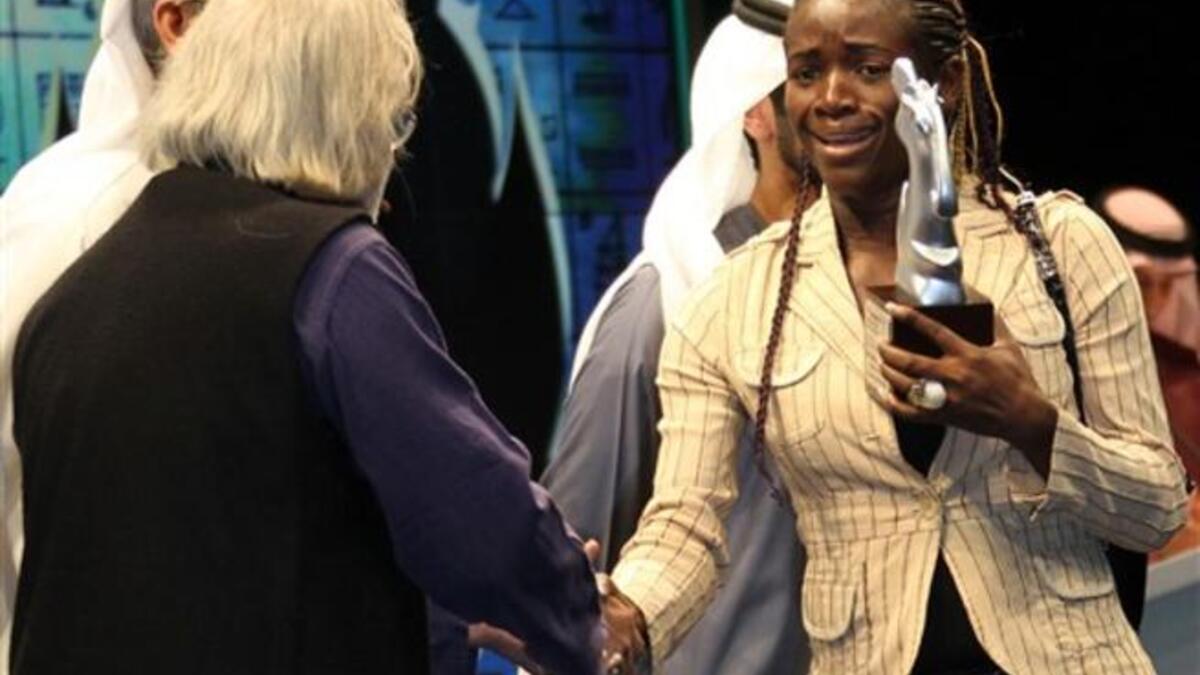 Cameroonian director Ariane Astrid Atodji (R) receives the special jury price for her documentary film Koundi and the National Thursday.