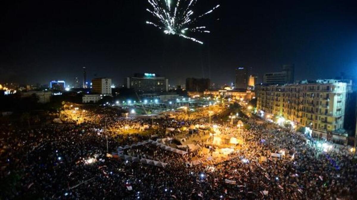 Fireworks light the sky as thousands of Egyptians gather to demonstrate against President Mohamed Morsi and the Muslim Brotherhood in Cairo's landmark Tahrir Square (AFP)