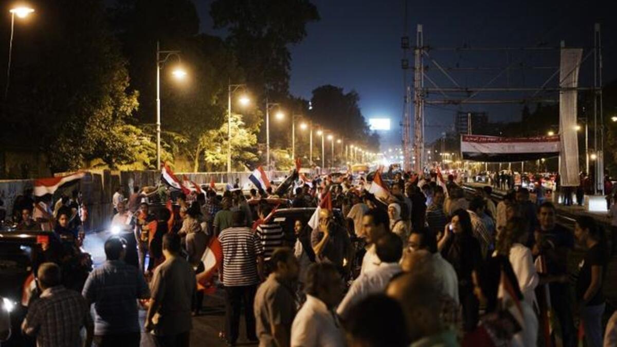 Hundreds of Egyptian protesters wave national flags and shout slogans against President Mohammed Morsi outside the presidential palace (AFP)