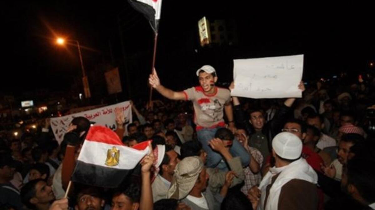 Yemenis Yell outside the Egyptian Embassy in Sana'a in commemoration of a crashing fall following a 30-year regime.