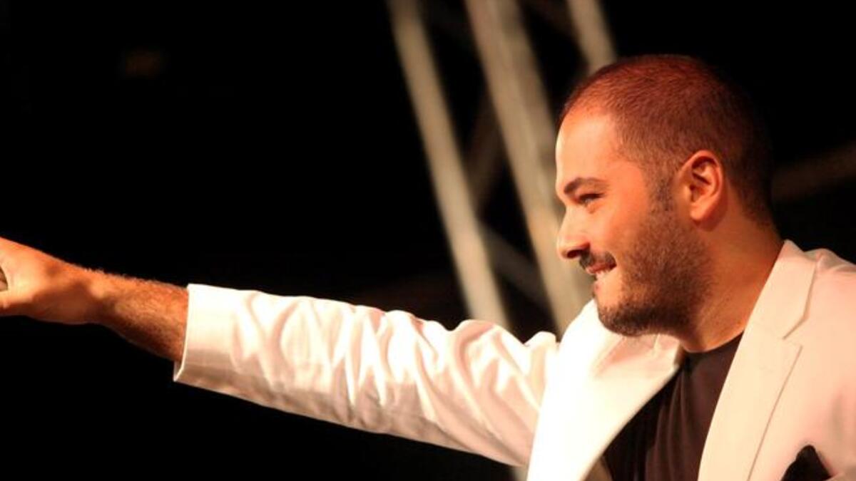 Rami Ayyash sings at the Baysour Festival, before a crowd of 10,000 fans. The festival was sponsored by Lebanese Cabinet Minister, Ghazi Aridi.