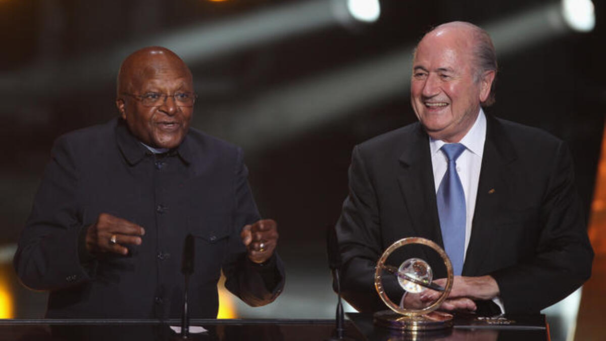 Archbishop Desmond Tutu (L) of South Africa receives the Presidential award from Sepp Blatter (R) President of FIFA.