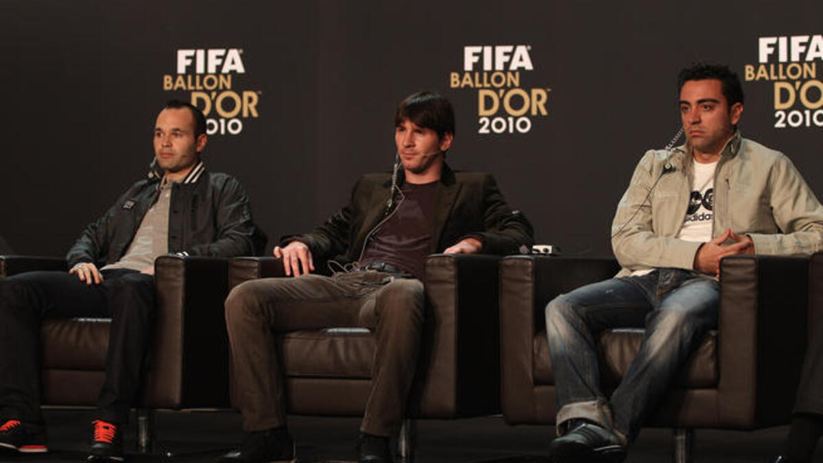 Lionel Messi (C) of Argentina alongside Xavi (R) and Andres Iniesta (L) of Spain during a press conference ahead of the FIFA Ballon d'or Gala.