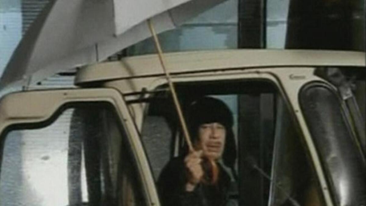 Hiding under the umbrella: Coined the 'umbrella' or 'I'm still in Tripoli' speech, apologizing that he'd love to say more than his 
2 minutes worth but that rain prevented him (as the people amassed
under the showers to register their discontent). It's a good thing he doesn't live in England...