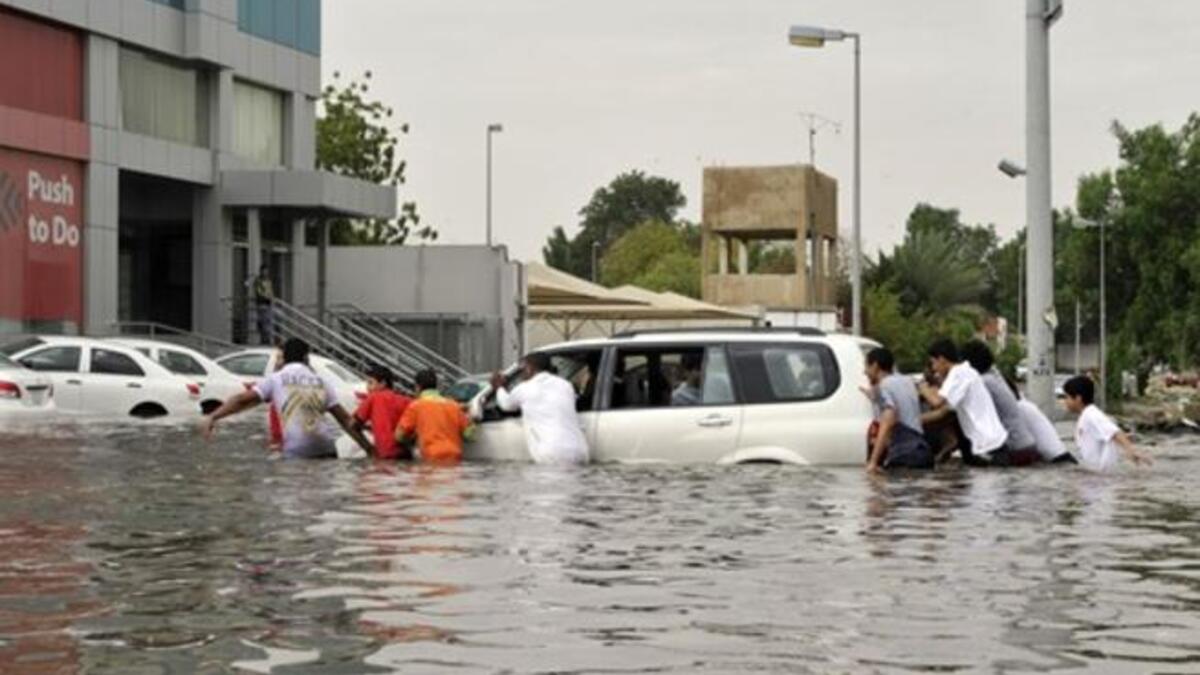 Saudi men keep pushing, doing as what they red sign says "Push to Do" (L).