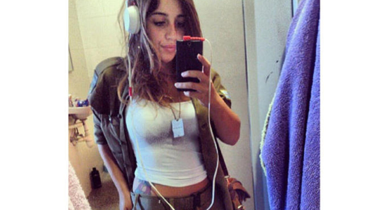 Hipster IDF girl doesn’t care what you have to say. She’s too busy flashing the tat and listening to the national anthem.