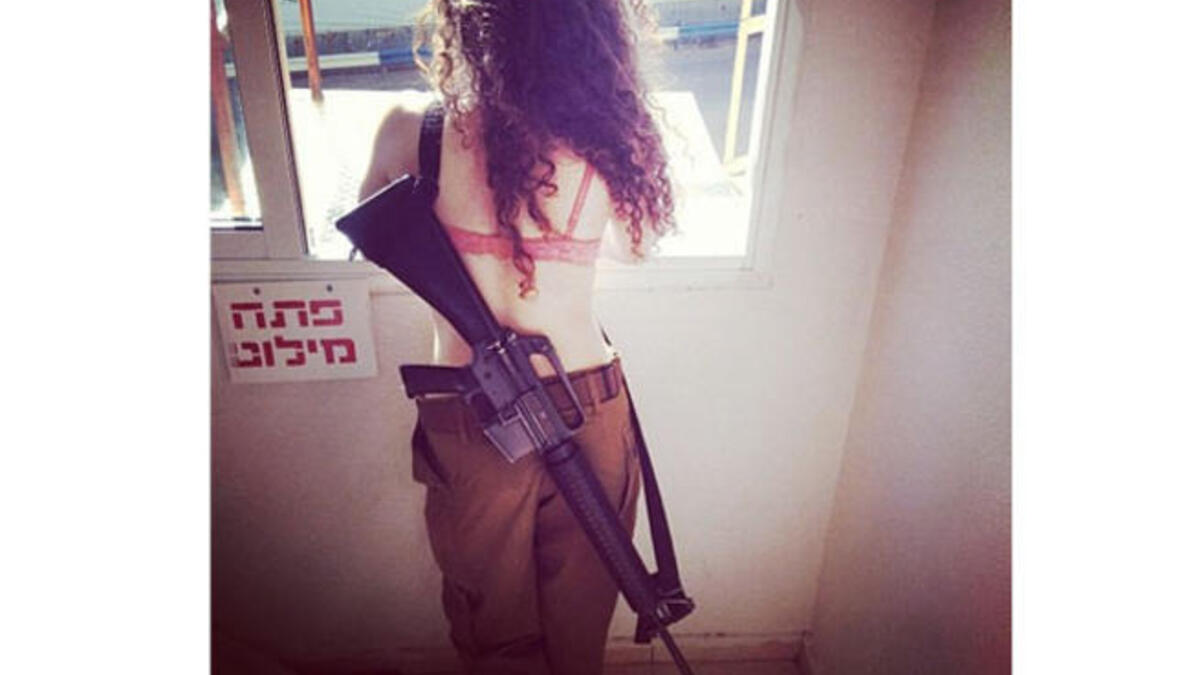 Luckily for this mysterious brunette, her massive gun gives her a little modesty.