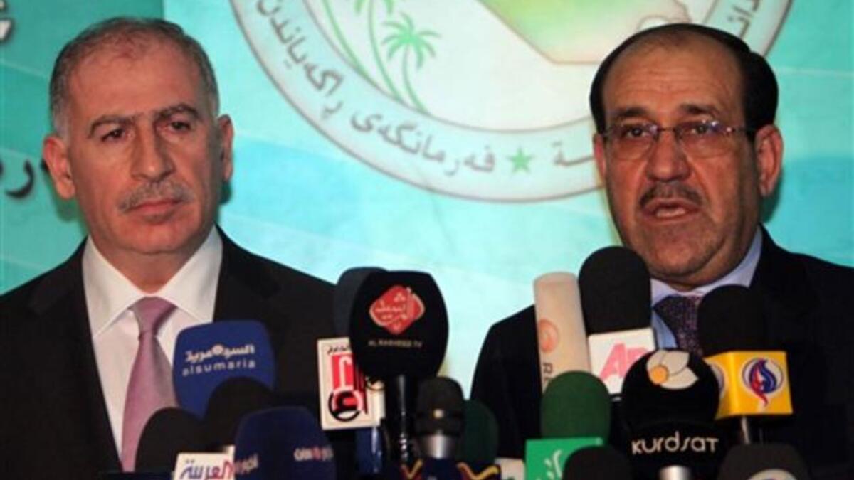 Iraqi Parliament Speaker Osama Al-Nujaifi (L) and Prime Minister Nuri al-Maliki hold a press conference in Baghdad.