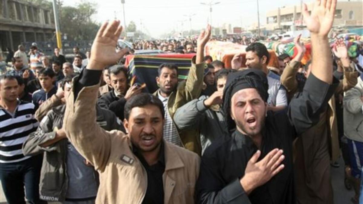 Iraqi Shiite Muslims carry the coffins of people killed in a bomb blast that targeted a convoy of pilgrims in the Ghazaliyah district of Baghdad.