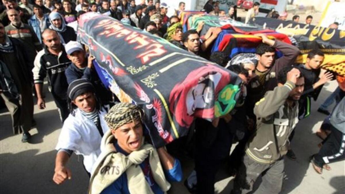 Iraqi Shiite Muslims carry the coffins, of people killed in a bomb blast that targeted a convoy of pilgrims in the Ghazaliyah district of Baghdad as Shiite Muslims prepare to mark the religious event of Ashura.