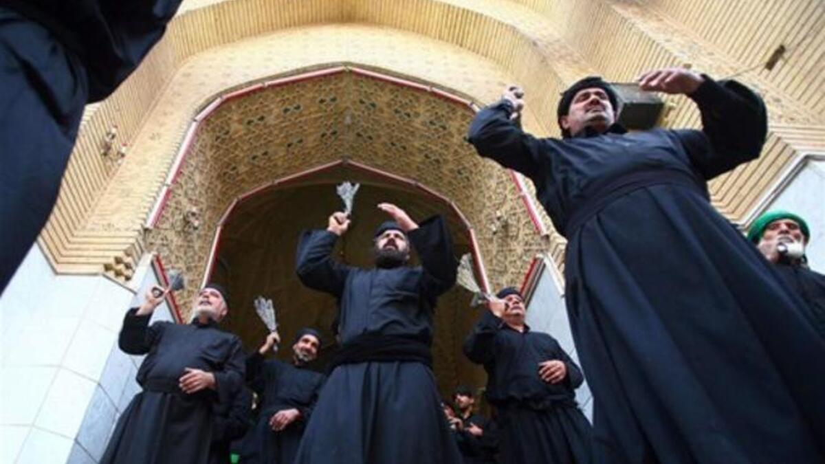 Shiite Muslim men flagellate themselves with chains, as they entering Imam Hussein's tomb where He was buried, in the shrine city of Karbala.