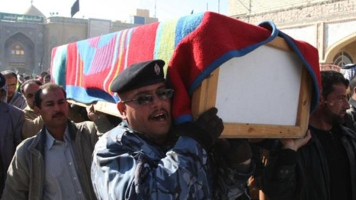 Iraqi mourners carry the coffin of a victim of a spate of blasts that hit across Iraq.