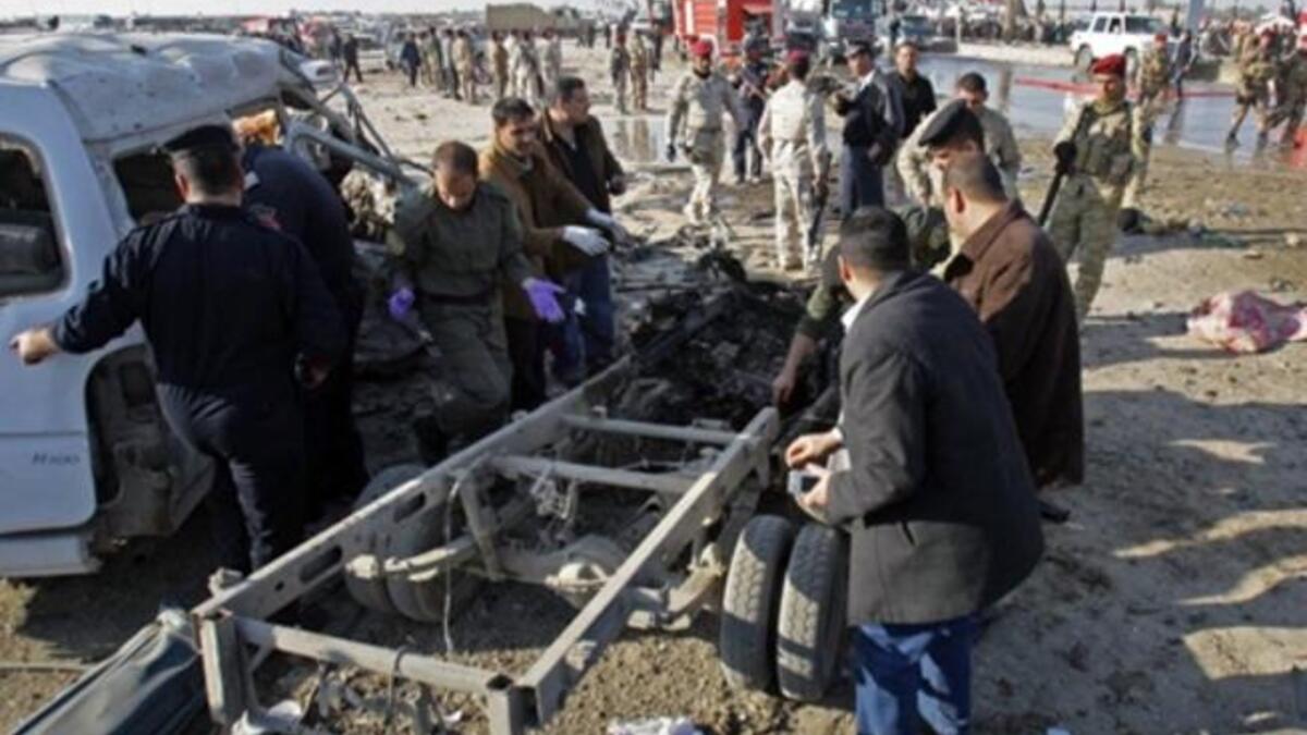 Members of Iraq security forces gather on the site of an explosion in Karbala.