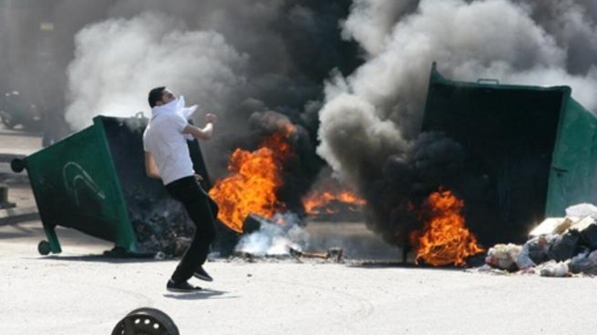 Garbage skips are set on fire.