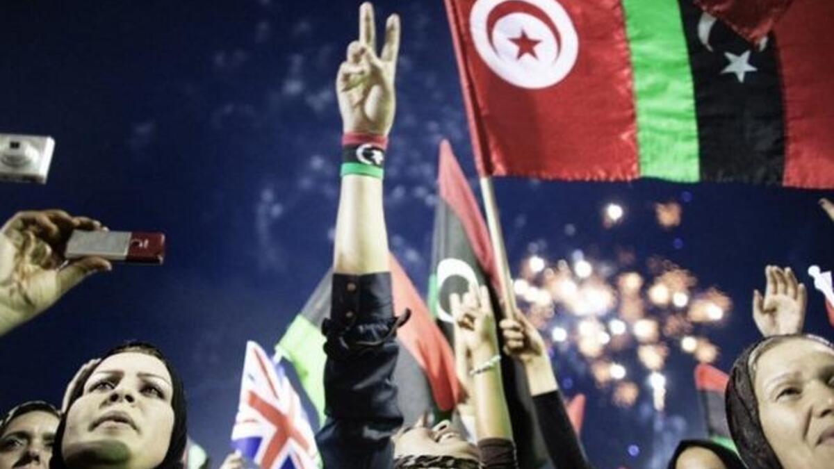 Libyans celebrate following the announcement of the liberation of the country in Martyr's Square in central Tripoli on October 
23, 2011 three days after ousted despot Moamer Kadhafi was killed.  Formerly Green Square, now Martyr's Square, saw bigger crowds during the Revolution, but  the occasion of freedom & a new Libya has drawn quite a crowd.