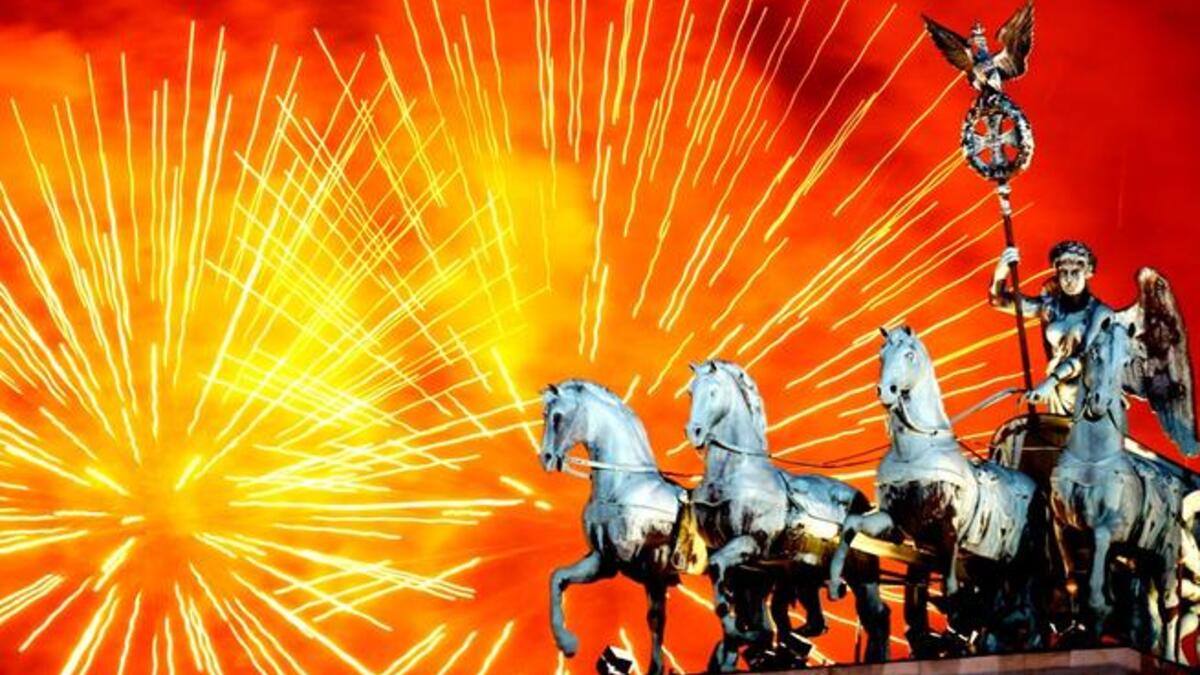 Fireworks explode over the Quadriga statue atop the Brandenburg Gate on New Year's Eve in Berlin, Germany. According to the media, up to one million people celebrate the country's biggest New Year's Eve Party.