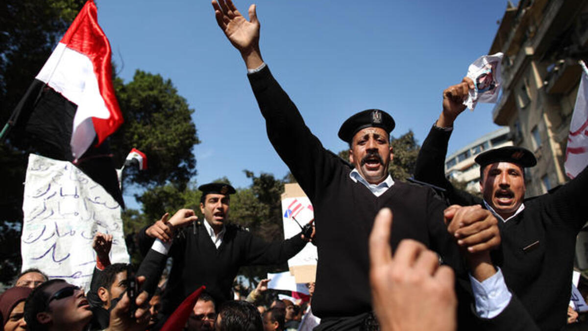 Policemen are carried during a demonstration in support of President Hosni Mubarak.