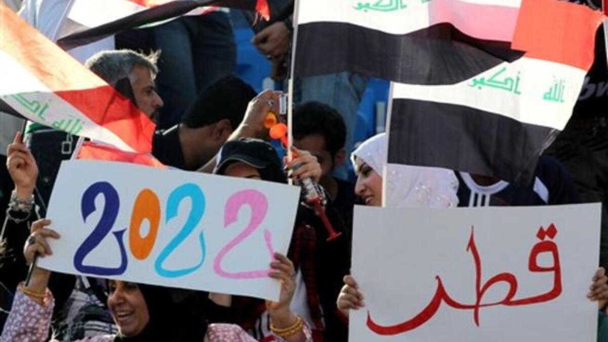 Iraqi football fans show their support to Qatar's bid to host the 2022 World Cup as they attend the 20th Gulf Cup semi-final football match between Iraq and Kuwait in the southern Yemeni city of Aden. Kuwait won on penalty shots after a 2-2 draw.