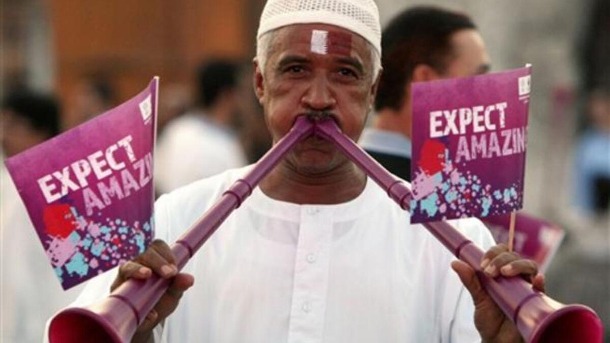 A Qatari man blows vuvuzela trumpets at Doha's traditional souk as people gather to follow FIFA's decision on who will host the 2022 World Cup.