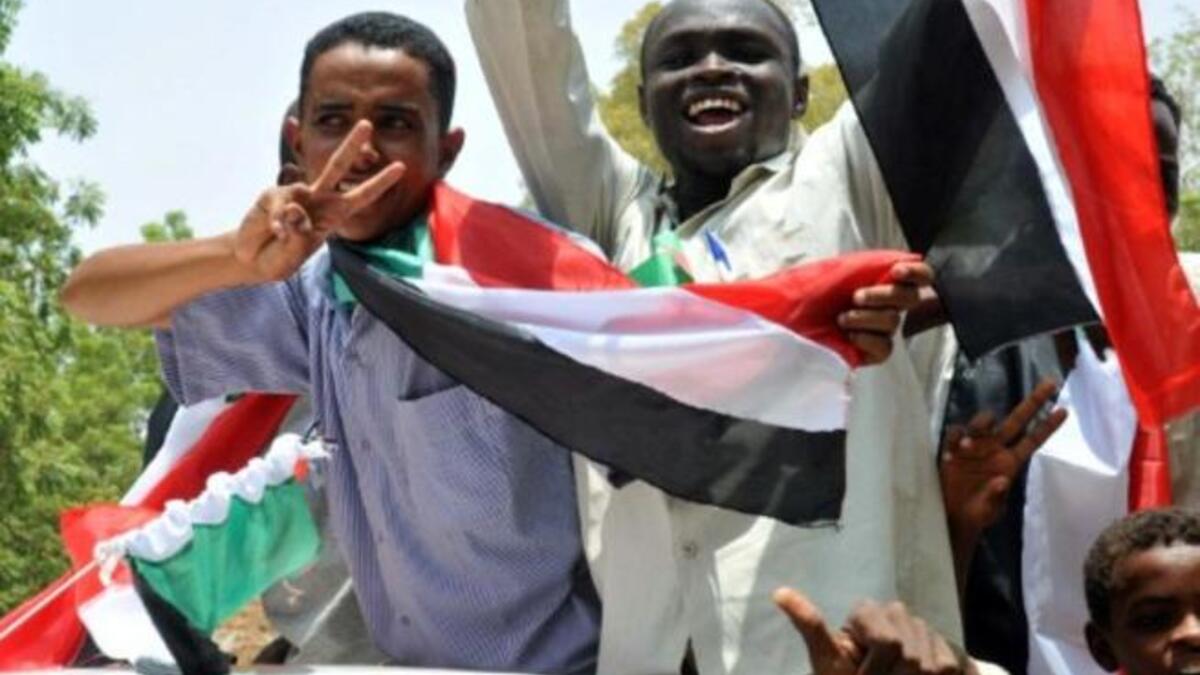 Sudanese wave their national flag as they celebrate in Khartoum after South Sudan proclaimed independence from the north, creating the world's newest nation and splitting Africa's largest country in two.