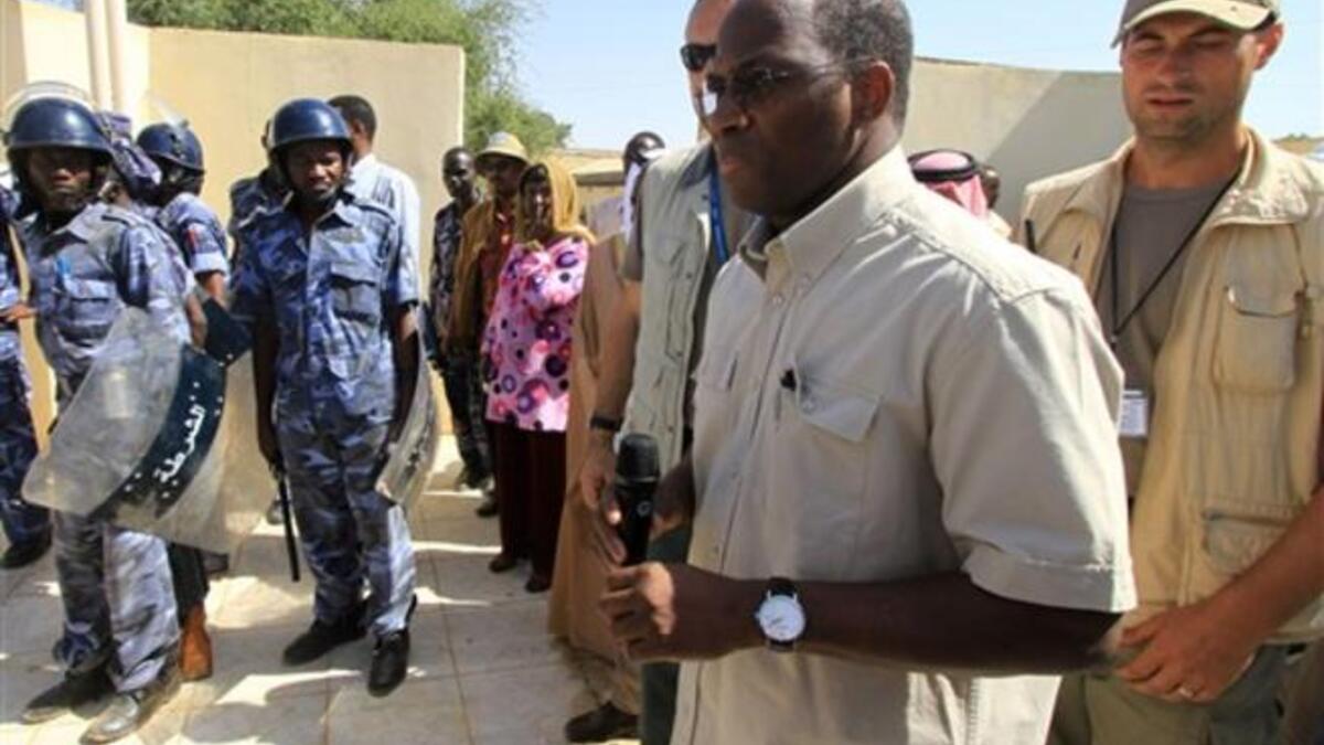 Djibril Bassole, chief negotiator for the UN and the African Union, is surrounded by bodyguards and Sudanese policemen as he prepares to address students protesting outside the University of Zalingei.