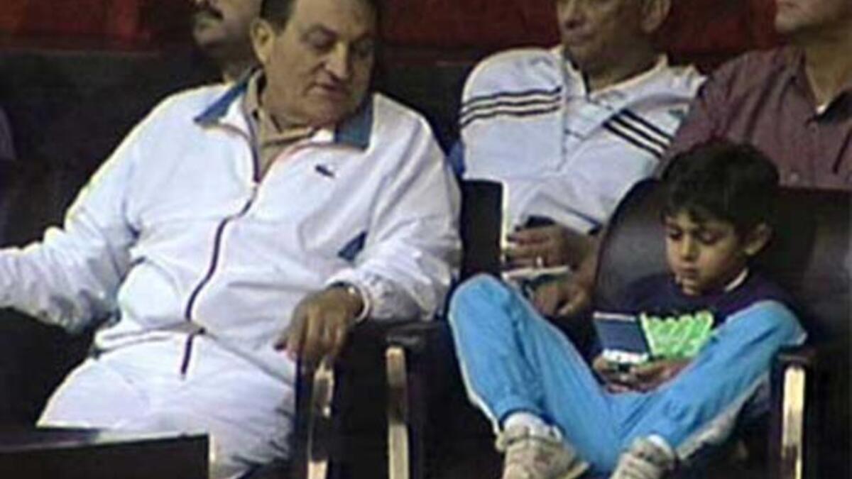 Potential heir nipped in the bud: The presidential couple's young grandson, Muhammad Mubarak, died aged 12 from complications of a health crisis. The eldest grandson of Presiden Mubarak , son of Alaa Mubarak, a businessman not involved in politics, here watching a sports game with Grandpa.