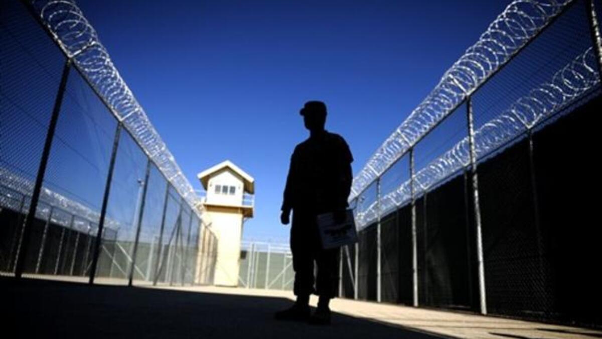 A photo shows a US captain silhouetted at the Bagram prison, north of Kabul, during a media tour. leaked American diplomatic cables revealed that Afghan President Hamid Karzai has ordered the release of numerous dangerous criminals and drug traffickers detained by US-led coalition forces.