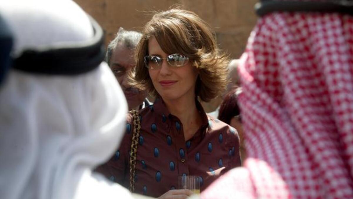 Asma Al Assad in a patterned shirt.