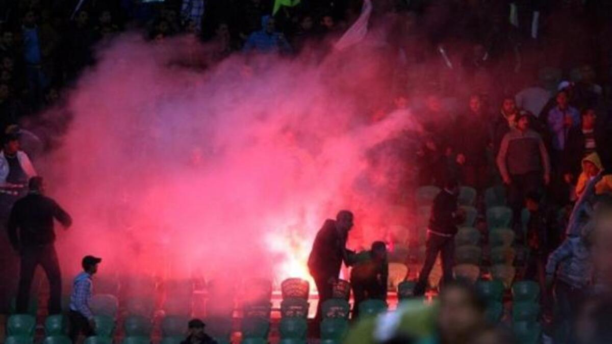 Flares thrown in the stadium during clashes that erupted after a football match between
Egypt's Al-Ahly & Al-Masry teams. As taken from the Arabic for 'crude weaponry'- 'white weapons'- were used for most 
of the killings-- pocket knives, stones & bare hands. Sources say an al Masry fanatic (Abo Alarabi) rushed into the stadium
with a taser gun.