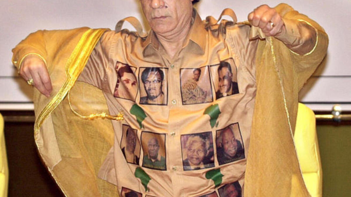 Proudly bearing his African 'kingdom's' heroes for all to get a closer look at. Leader of the African Union sports the ultimate Africa pride golden shirt marked in maps of the continent and faces of the Great Africans.