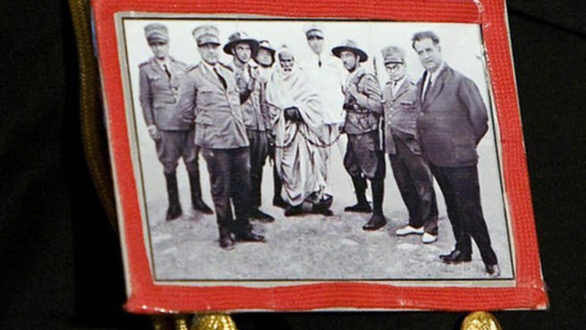 Brazenly sports this self-fashioned badge of Omar Mukhtar national hero who died resisting Italian rule of Libya ( on a visit to Berlusconi&amp;#039;s Italy no less)