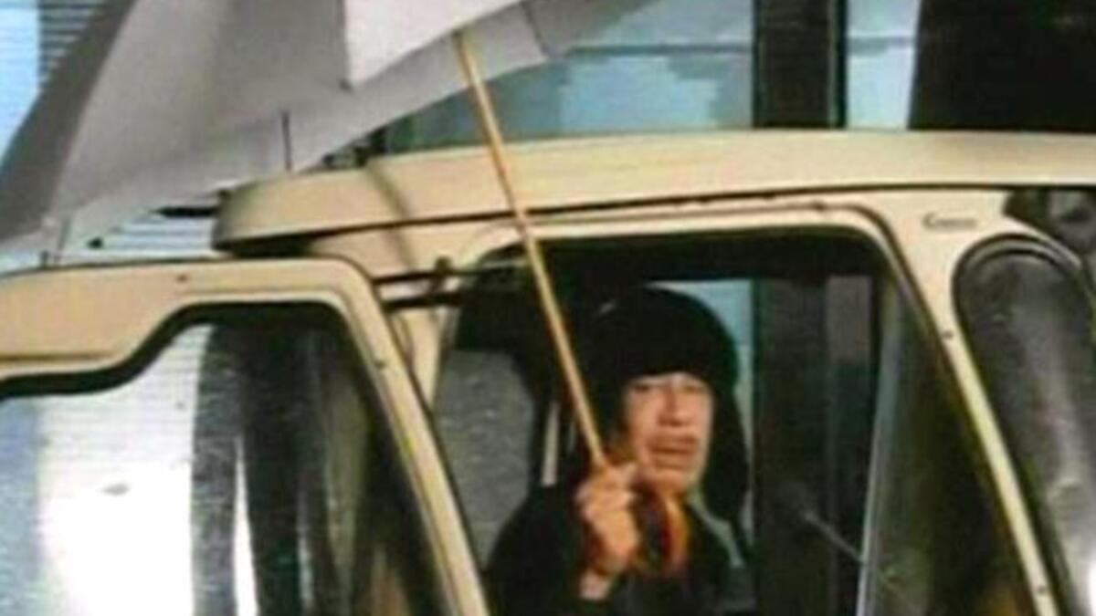 Libya's rainy day is Gaddafi's theatrical spotlight: Feb 22- Gaddafi makes first public appearance to disprove his fleeing- in a
stilted surreal show : Bizarre starts to be the buzzword, together with the infamous umbrella pic.  He expresses
 that, far from leaving Libya, he would "die a martyr".