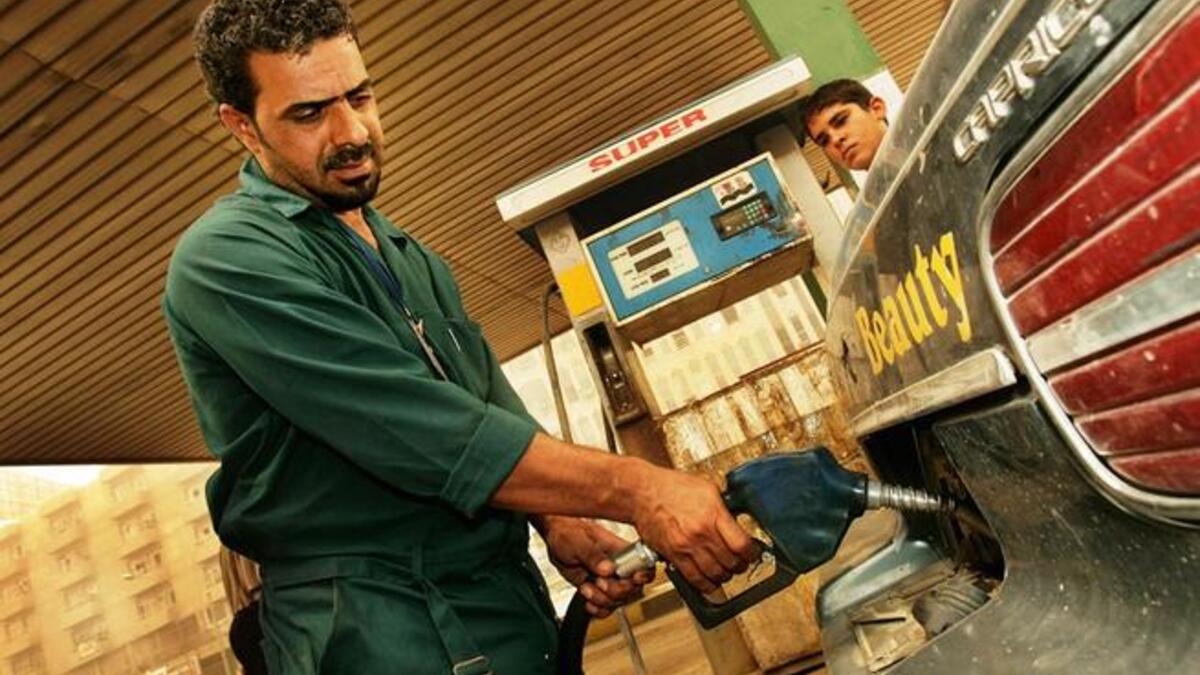 Iraqi man pumps gasoline at station