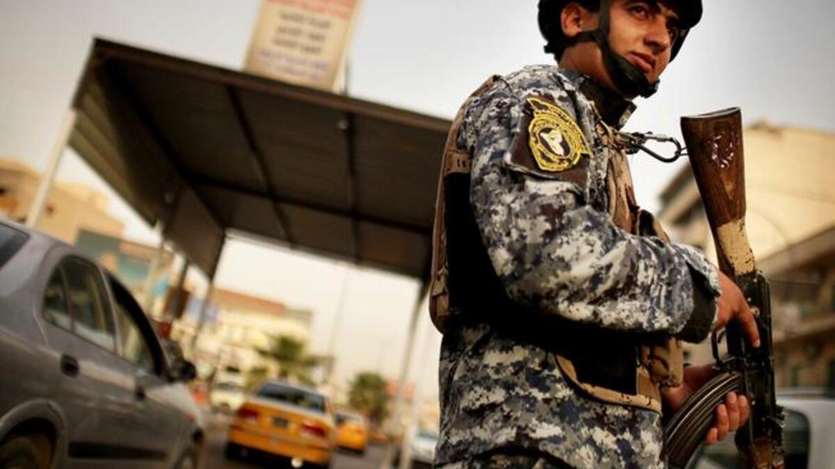 An Iraqi soldier wields a gun