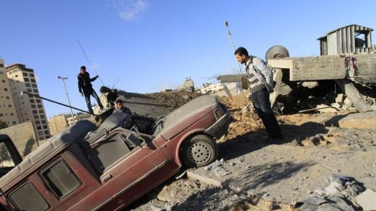 Palestinians inspect a destroyed Hamas compound after an Israeli strike overnight in Gaza City as Israel staged air raids in Gaza overnight, wounding 17 people.