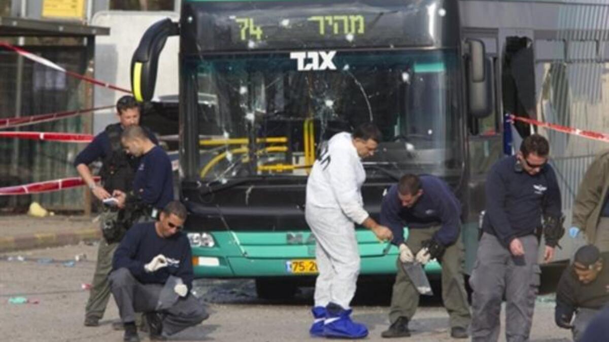 Israeli paramedics inspect the scene of an explosion next to a bus near Jerusalem's central bus station which left thirty people hurt