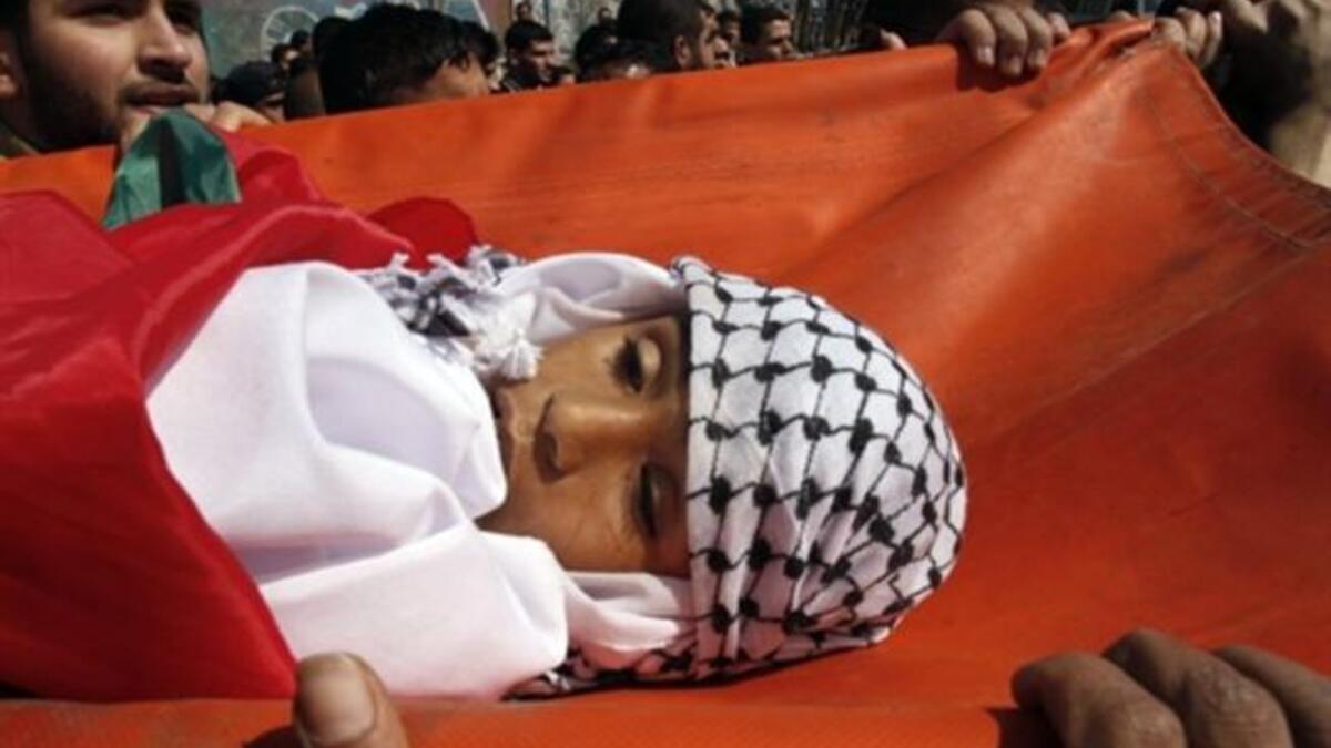 Palestinian mourners carry the body of 11-year-old Mohammed al-Helu during a funeral in Gaza City.
