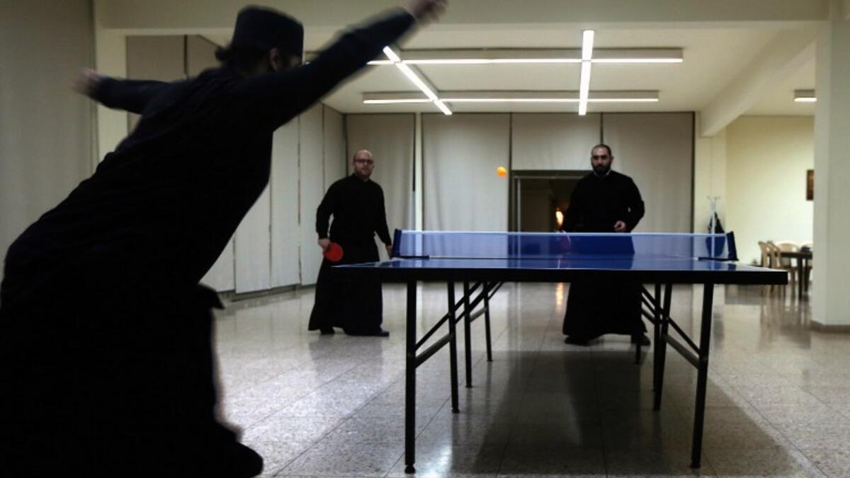 Greek Orthodox priests play tennis table during a break from their studies at the St. John of Damascus Institute of Theology in Balamand in northern Lebanon on March 2, 2016. The institute was established in 1832 and hosts students from all over the world.

PATRICK BAZ / AFP