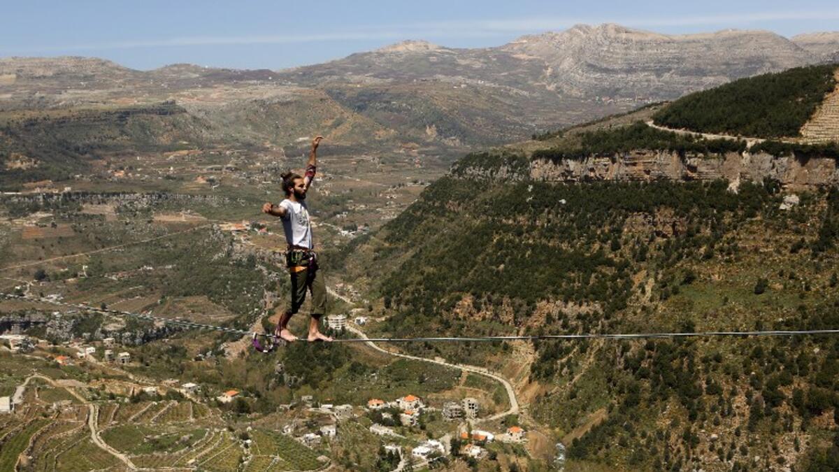Lebanese Gino Traboulsi walks on a tightrope over the valley of Afqa, North East of the capital Beirut, on April 3, 2016.
Patrick BAZ / AFP