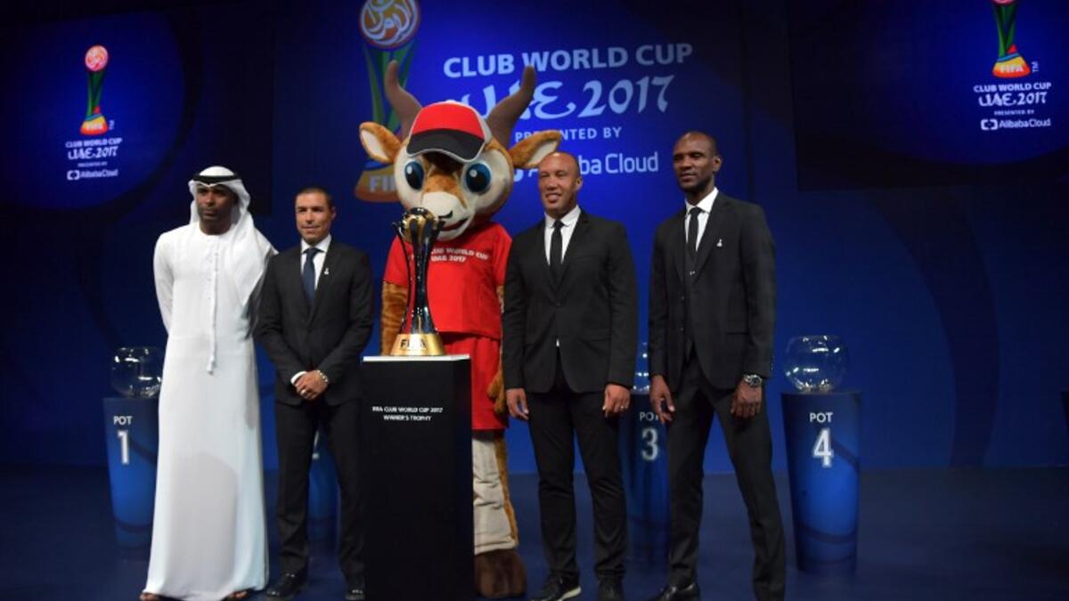 (L to R) FIFA legends Abdulrahim Jumaa, Ivan Cordoba, Mikael Silvestre and Eric Abidal pose for a photo next to the official trophy during the draw of the FIFA Club World Cup UAE 2017 football tournament in Abu Dhabi on October 9, 2017. The tournament will be held in Abu Dhabi and Al-Ain from December 6 to 16.
GIUSEPPE CACACE / AFP