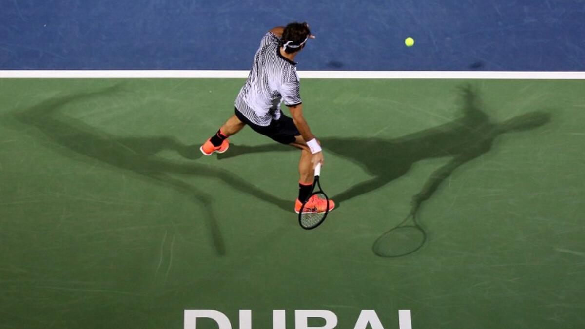 Roger Federer of Switzerland returns the ball to France's Benoit Paire during their ATP tennis match as part of the Dubai Duty Free Championships on February 27, 2017. MAHMOUD KHALED / AFP
