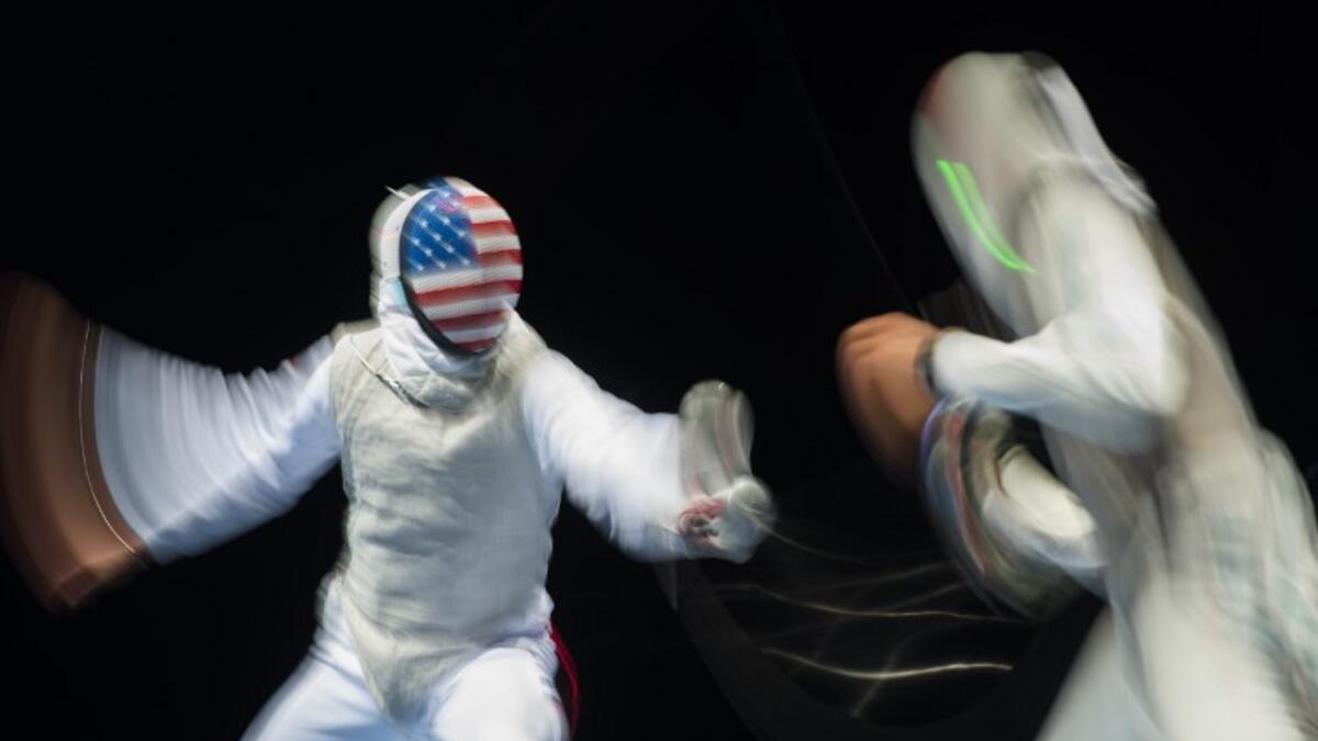 Picture taken with long time exposure shows Race Imboden (L) of the US and Mohamed Essam of Egypt fighting during a qualification duel of the Individual Men's Foil competition at the World Fencing Championships on July 23, 2017 in Leipzig, eastern Germany.
ROBERT MICHAEL / AFP