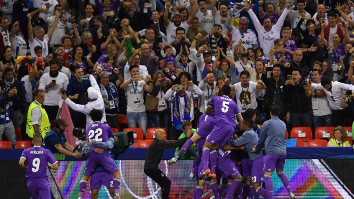 Real Madrid's players celebrate after scoring a goal during the UEFA Champions League final football match between Juventus and Real Madrid at The Principality Stadium in Cardiff, south Wales, on June 3, 2017.
Ben STANSALL / AFP