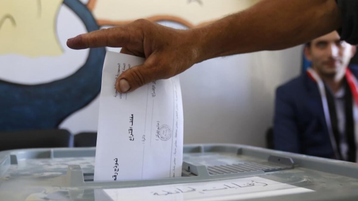 A man casts his ballot for Syria's first local elections since 2011, on September 16, 2018 in the southern Eastern Ghouta, on the eastern outskirts of the capital Damascus. (LOUAI BESHARA / AFP)