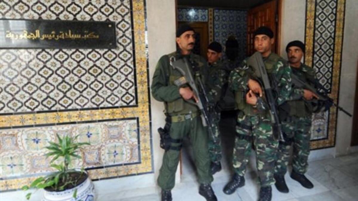 Tunisian presidential bodyguards stand guard by the president's office.
