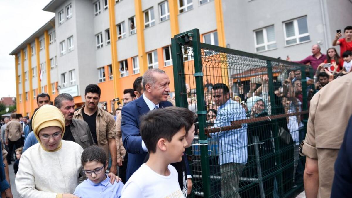 Turkey's President Recep Tayyip Erdogan, leader of the Justice and Development Party (AKP), his wife Emine and their grandchildren are greeted by supporters as they leave the polling station after casting their votes during snap twin Turkish presidential and parliamentary elections in Istanbul on June 24, 2018. (Bulent Kilic / AFP)